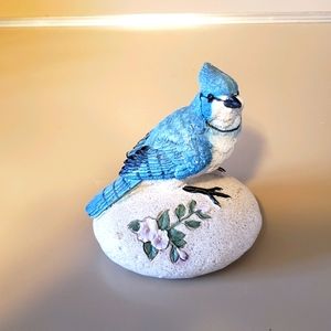 A pair of bird figurines perched on stone